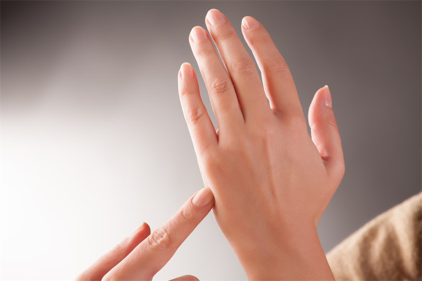 Woman doing EFT on the karate chop point. Emotional Freedom Techniques, tapping, a form of counseling intervention that draws on various theories of alternative medicine.