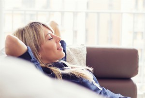 Relaxed young woman lying on couch